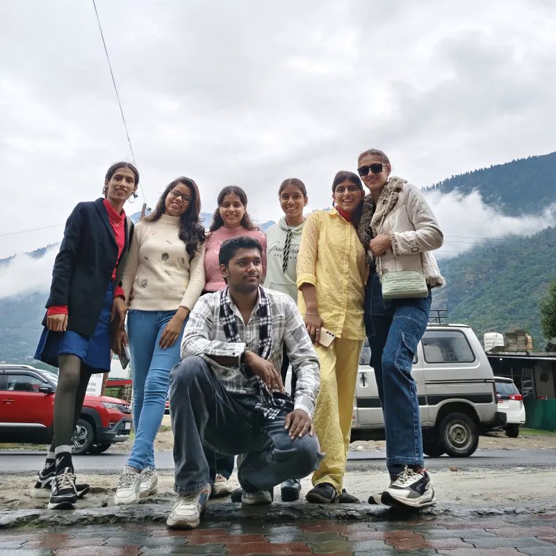Group of travelers with cloudy mountain backdrop