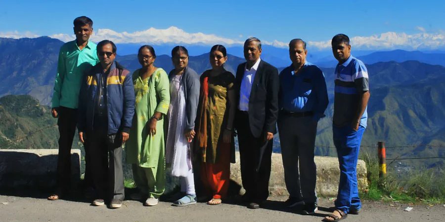Senior citizens group on Char Dham yatra with Himalayan view