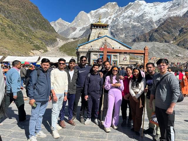 Family group holding Soulful Yatra banner at Kedarnath
